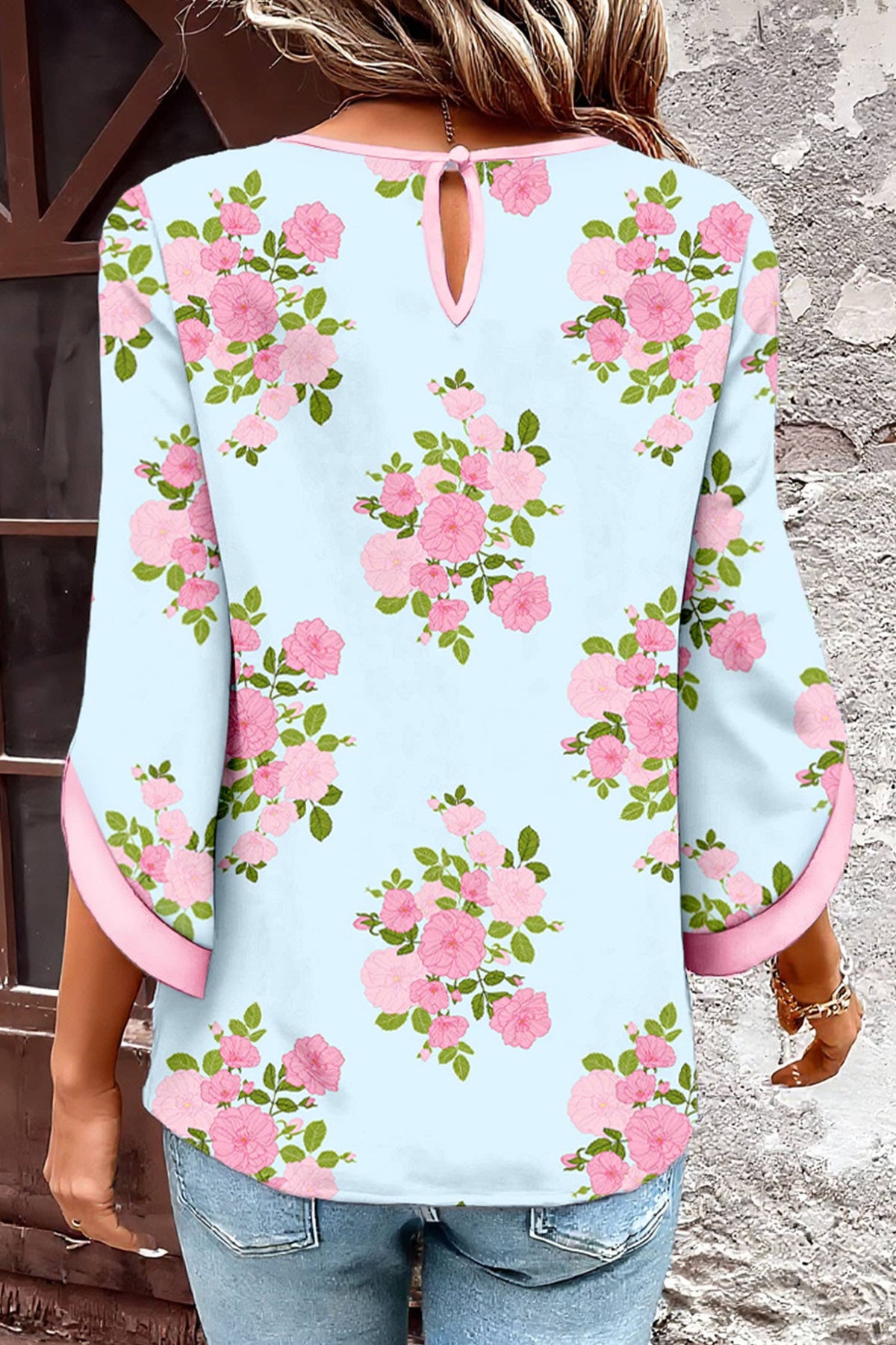 Light blue floral blouse with pink flowers worn by a person.