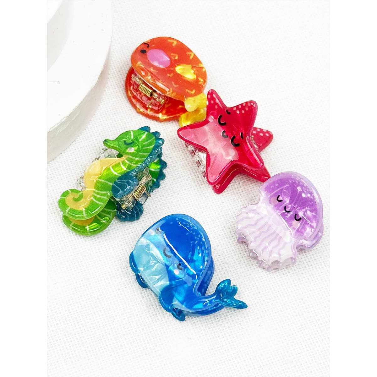 Colorful sea animal-shaped hair clips on a white background