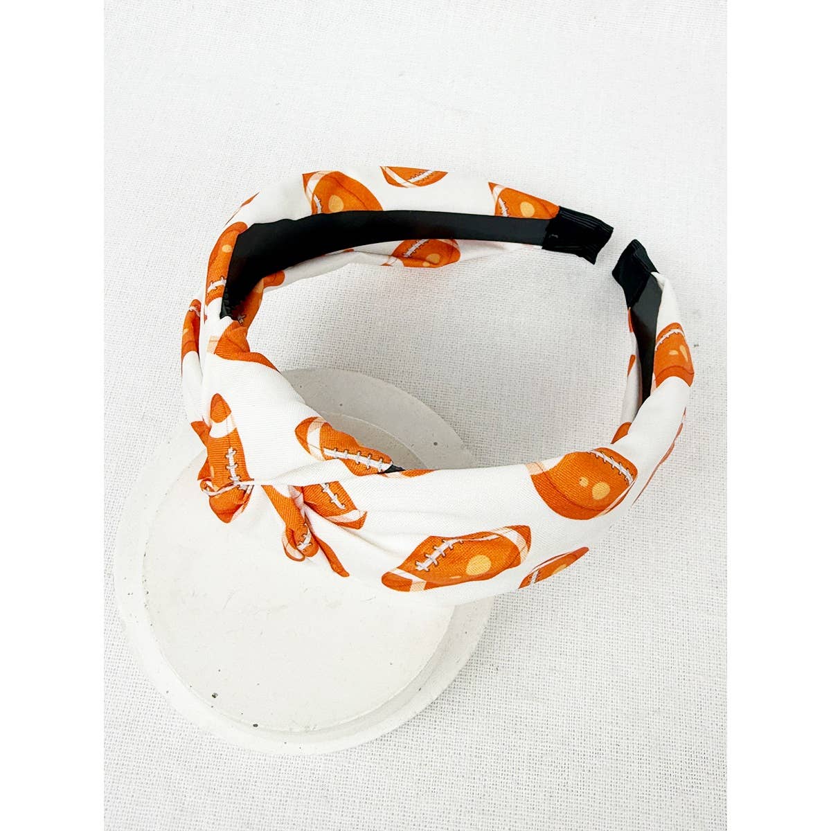 Headband with orange and white pattern on a white background