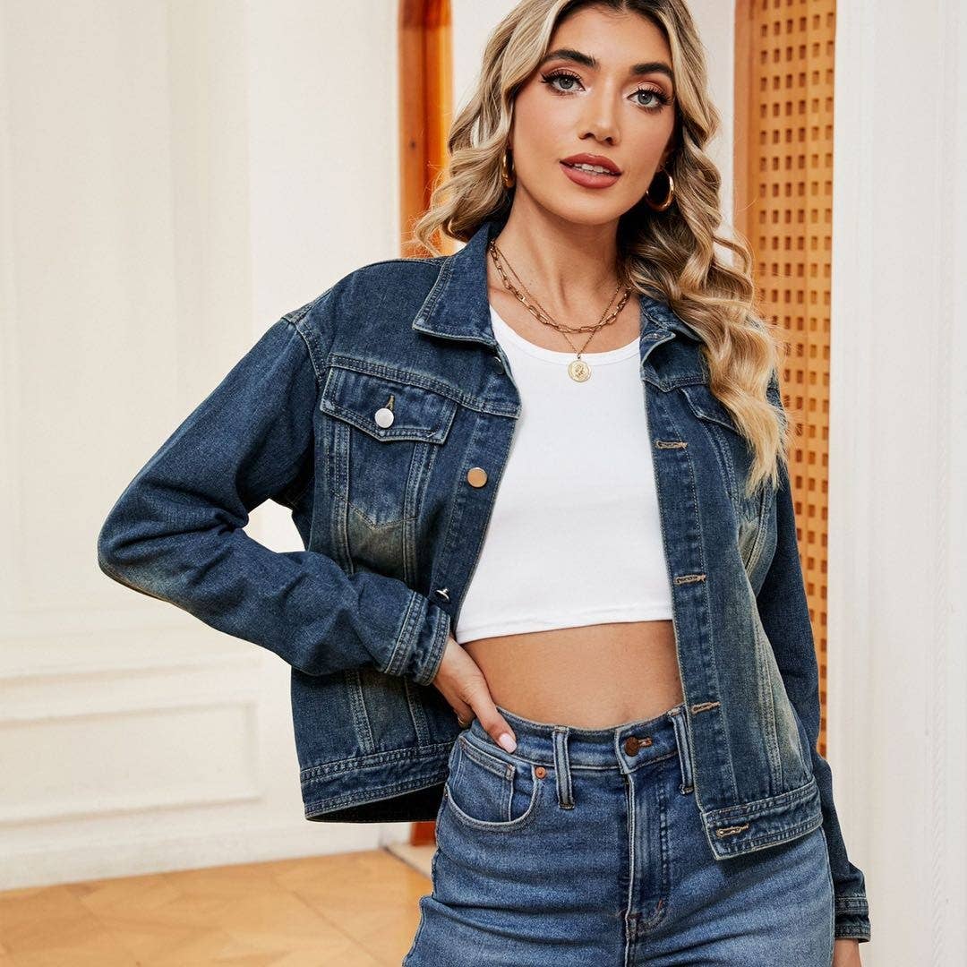 Woman wearing a denim jacket and jeans with a neutral background