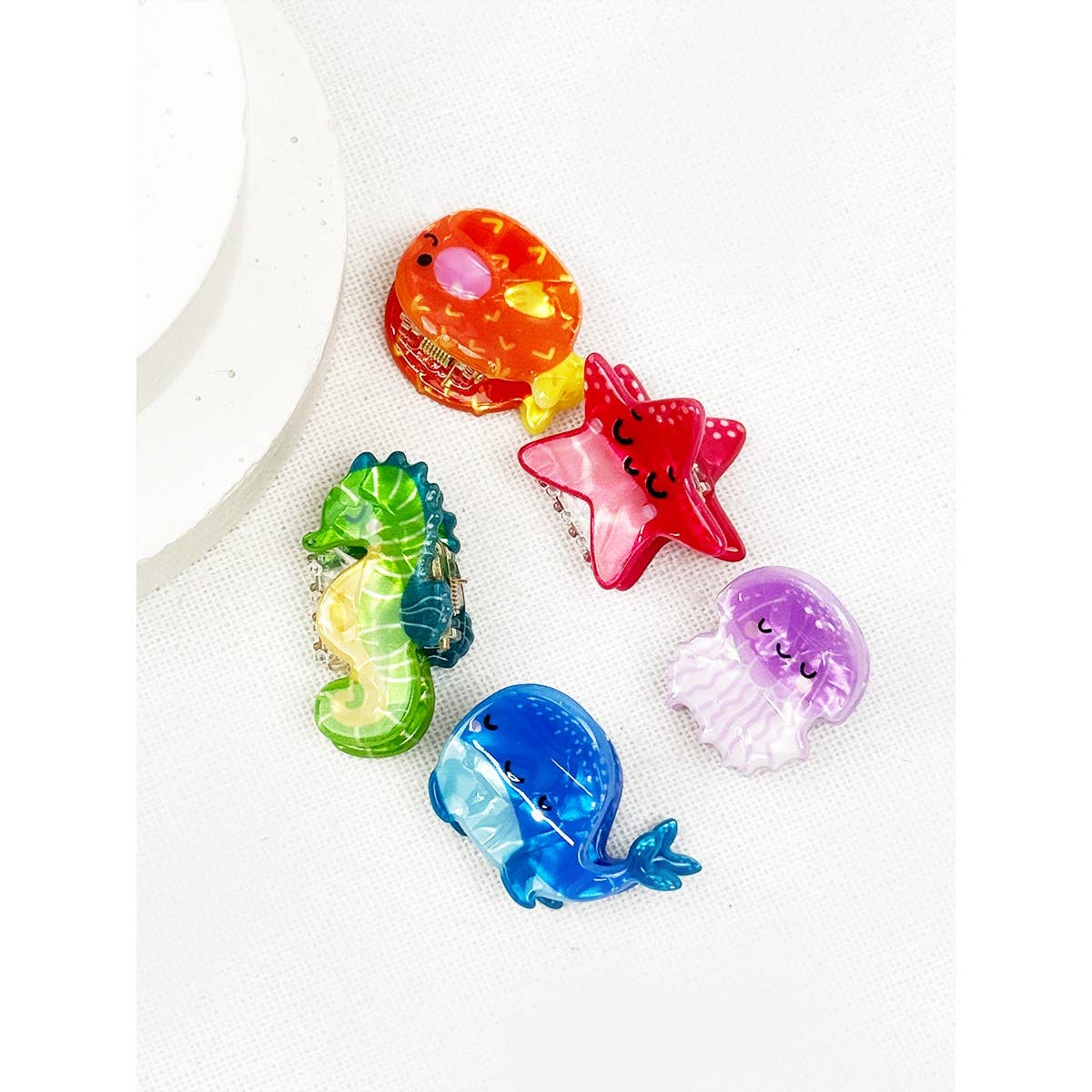Set of colorful sea animal hair clips on a white background