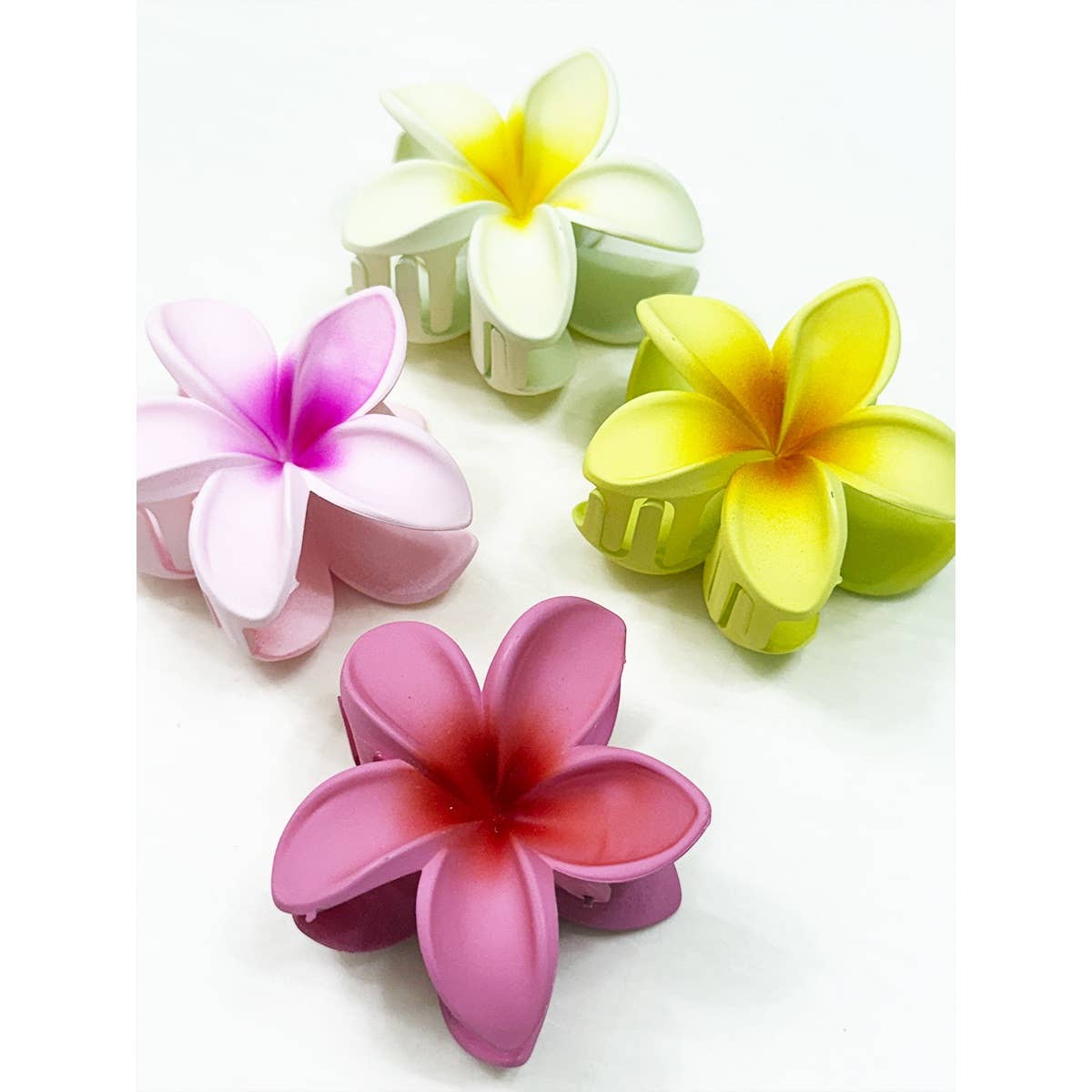 Colorful flower-shaped hair clips on a white background