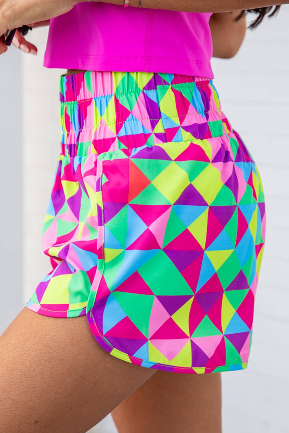 Colorful geometric-patterned shorts worn by a person against a white background
