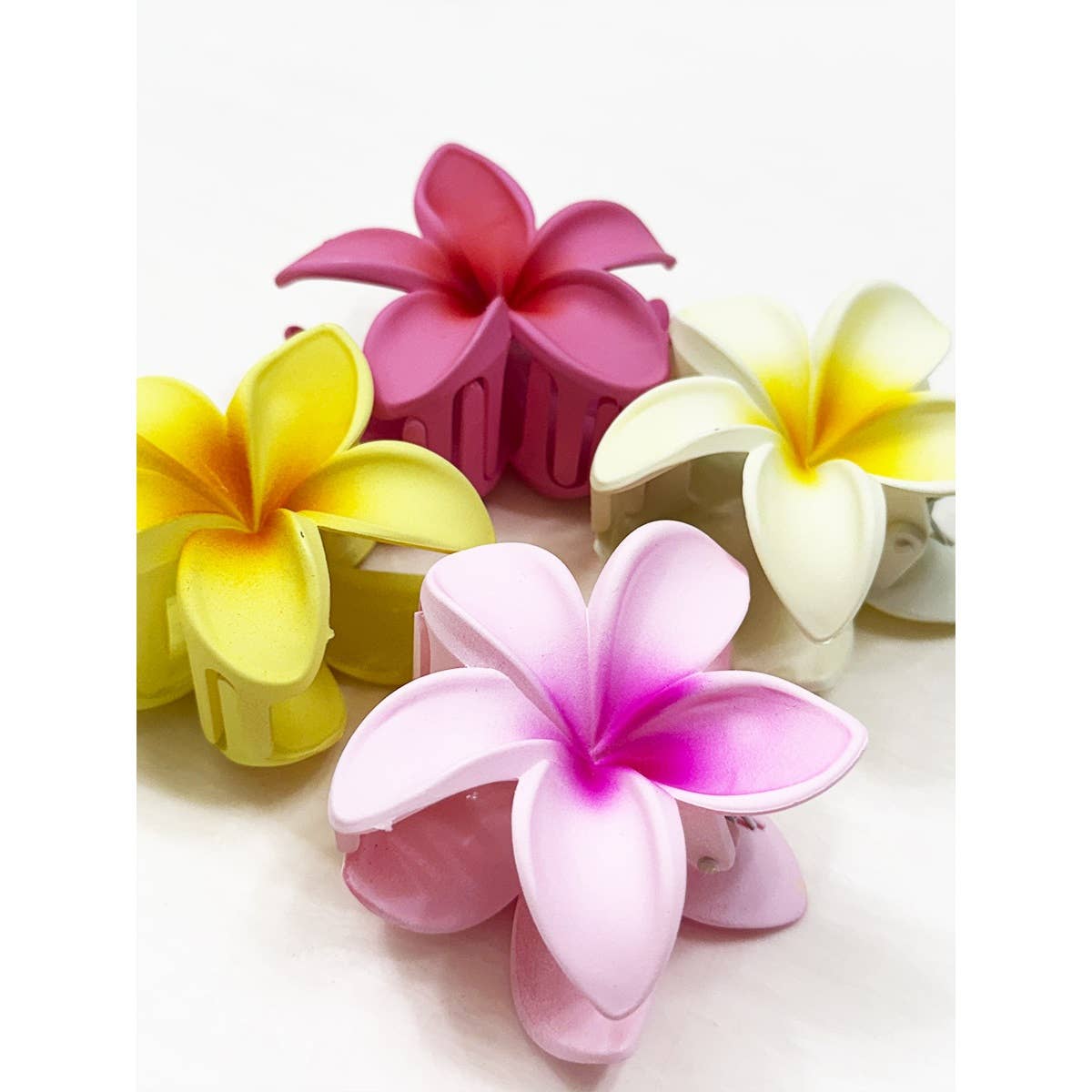 Colorful flower-shaped hair clips on a white background