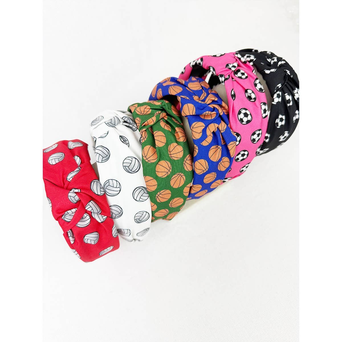 Set of colorful sports headbands with sports-themed patterns on a white background