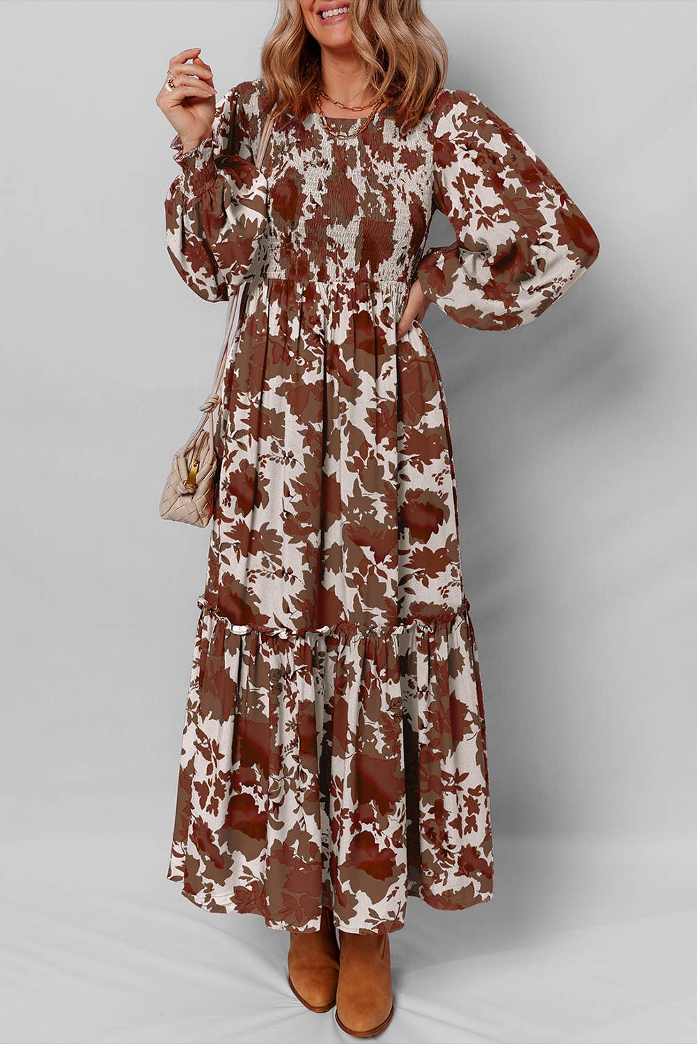 Woman wearing a floral dress with long sleeves on a plain background