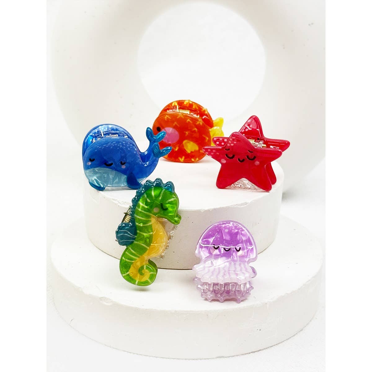Colorful sea-themed hair clips on a white base