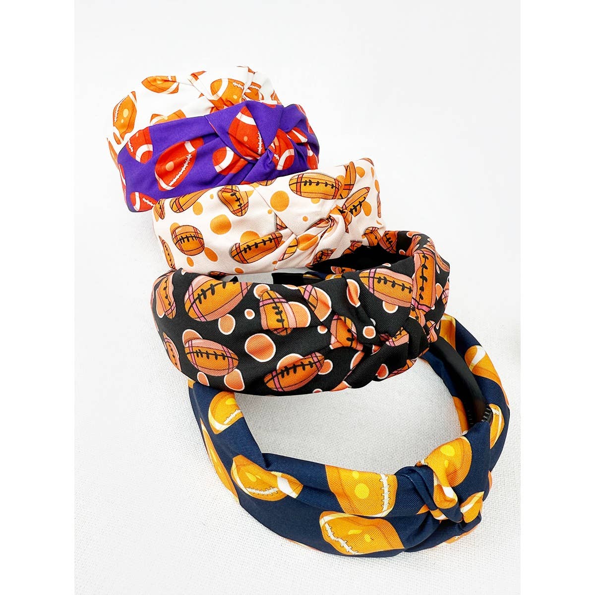 Set of four colorful headbands with football themed designs on a white background