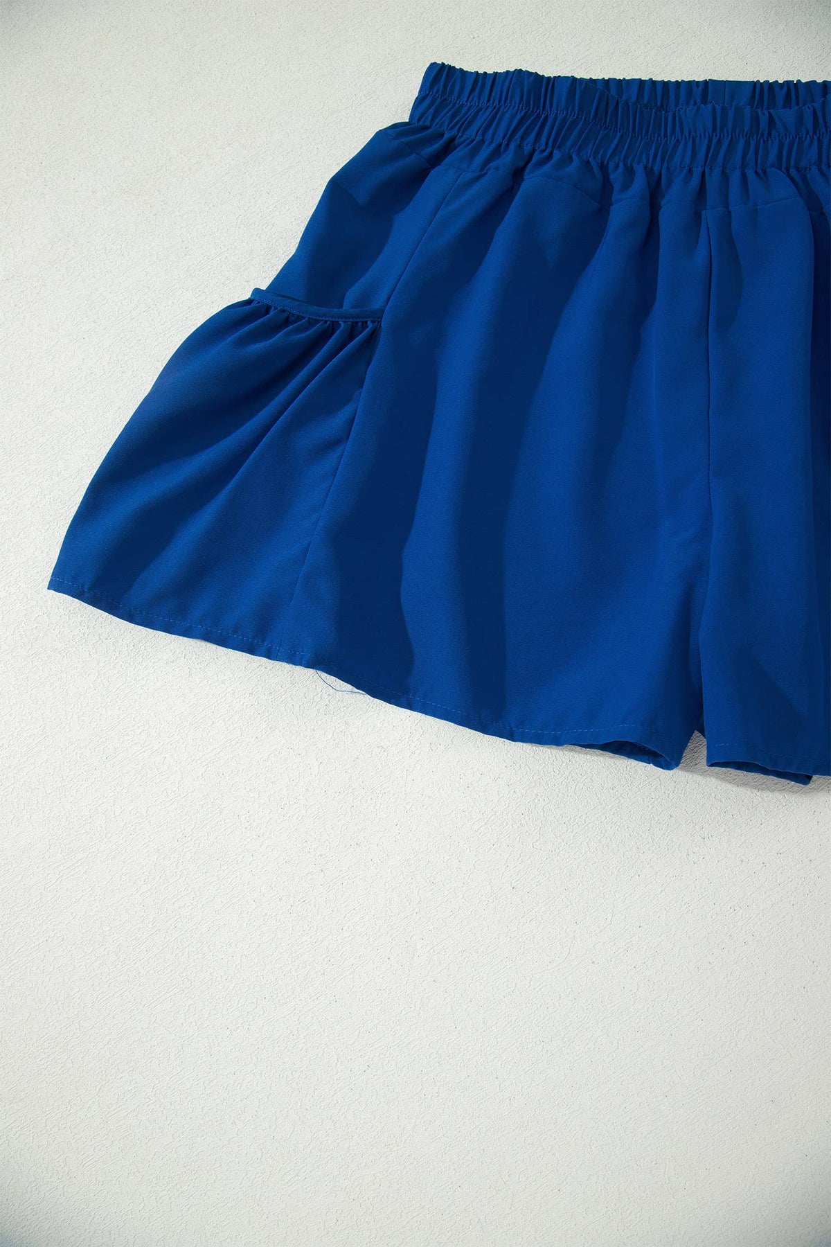 Blue shorts on a light gray background