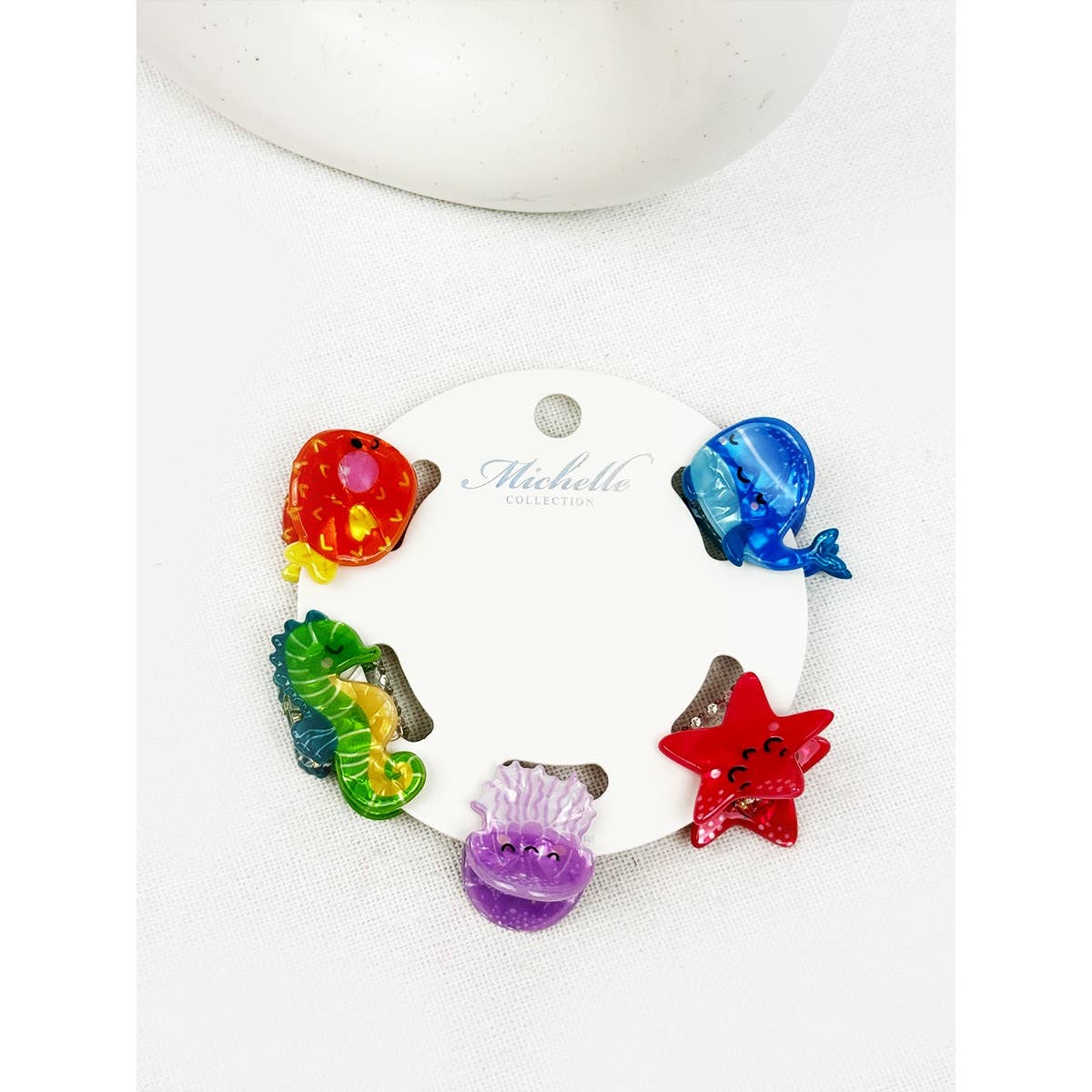Colorful sea creature hair clip set on a white background with a branded card.