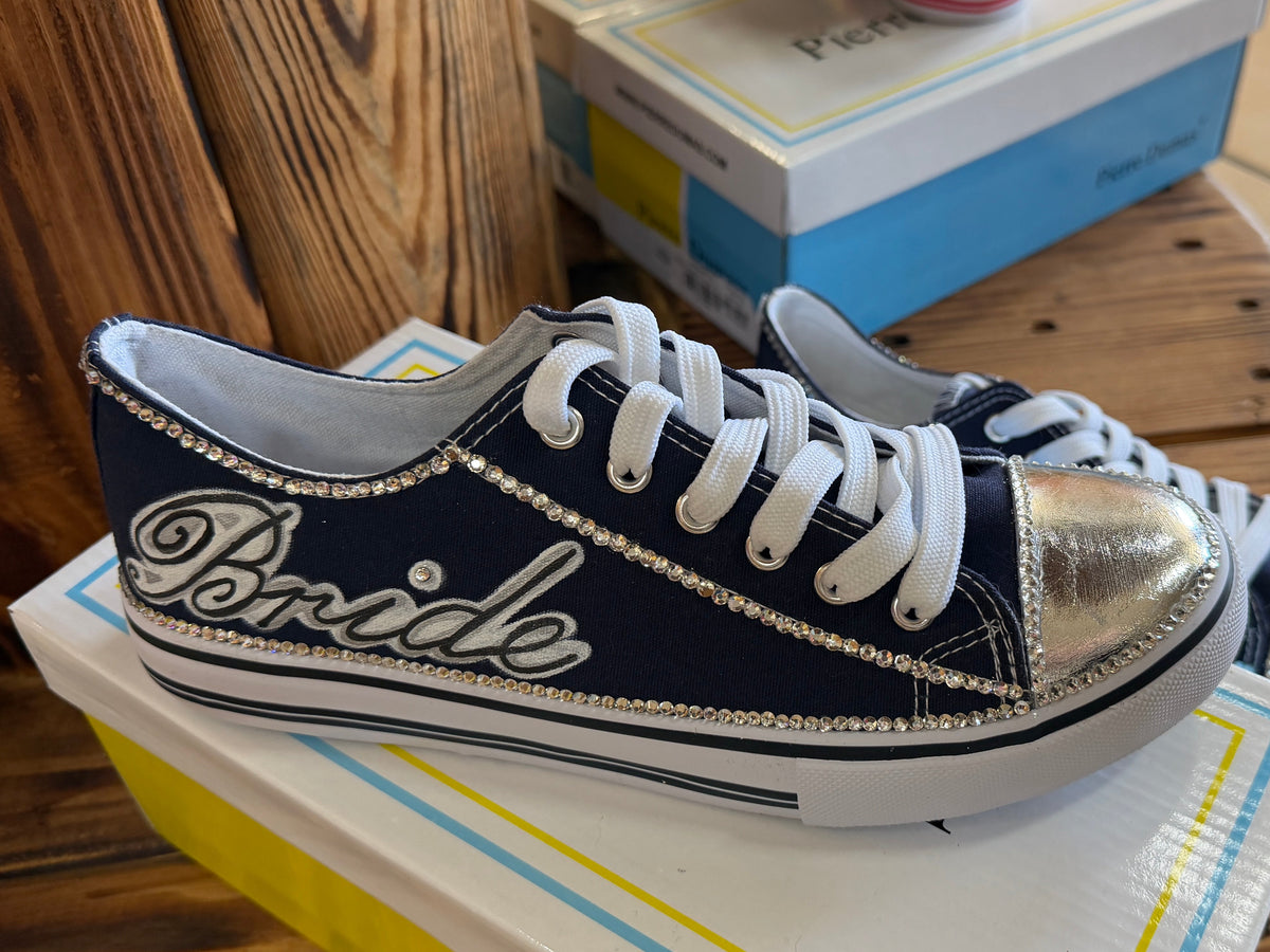 Navy and white sneaker with 'Bride' text painted on, with added rhinestones.
