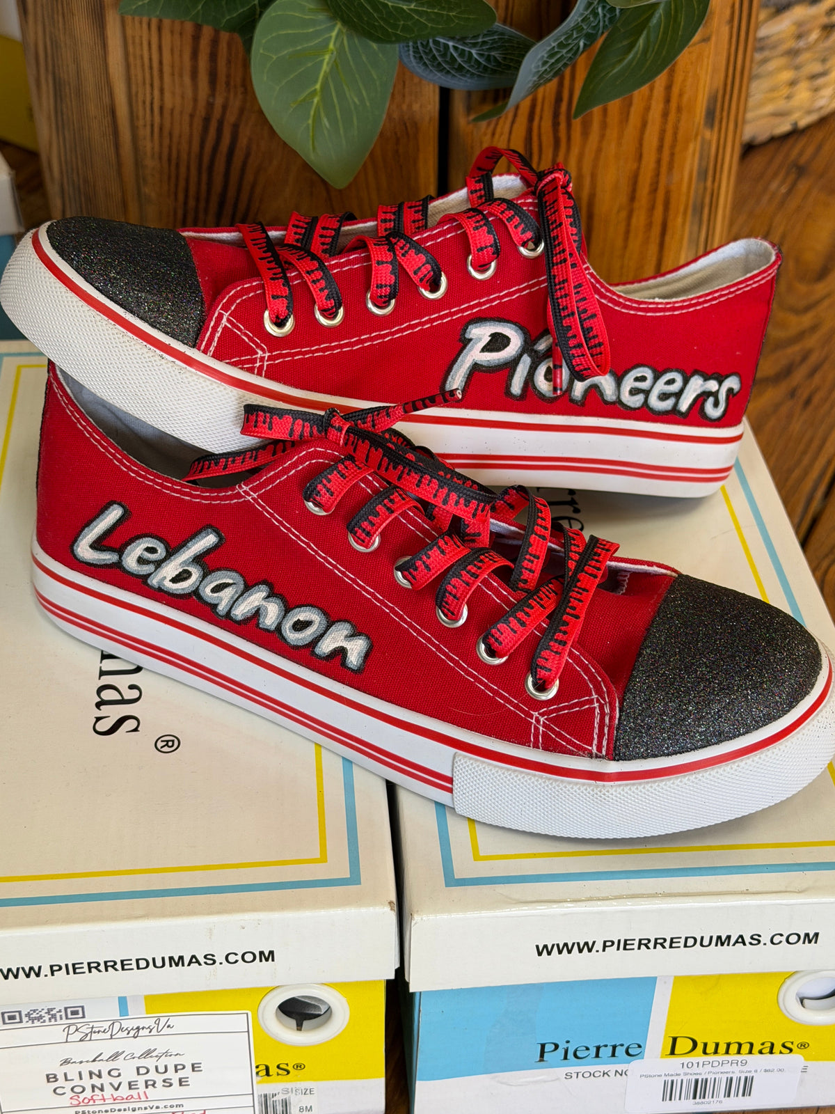 Red sneakers with 'Lebanon' and 'Pioneers' text painted, with black glitter toe box, and red and black drip shoelaces.