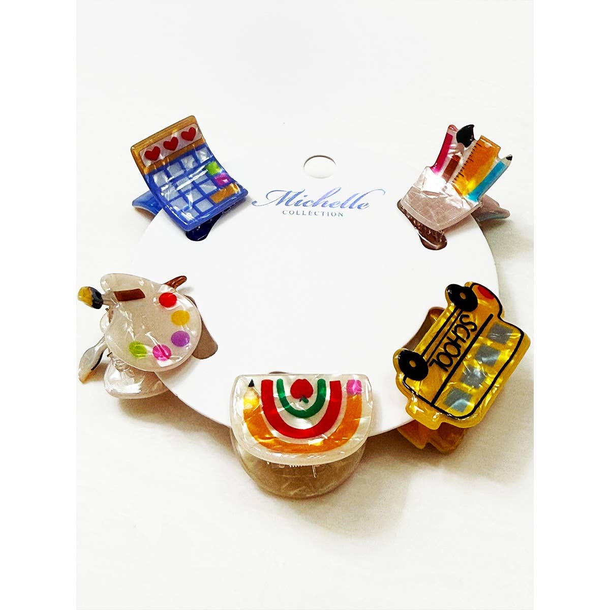 Set of colorful school themed hair clips on a white background with 'Michelle Collection' branding.