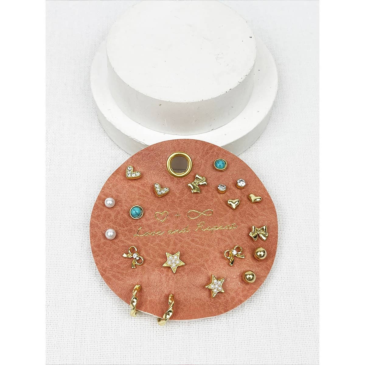 Round  jewelry card with various earrings on a white background