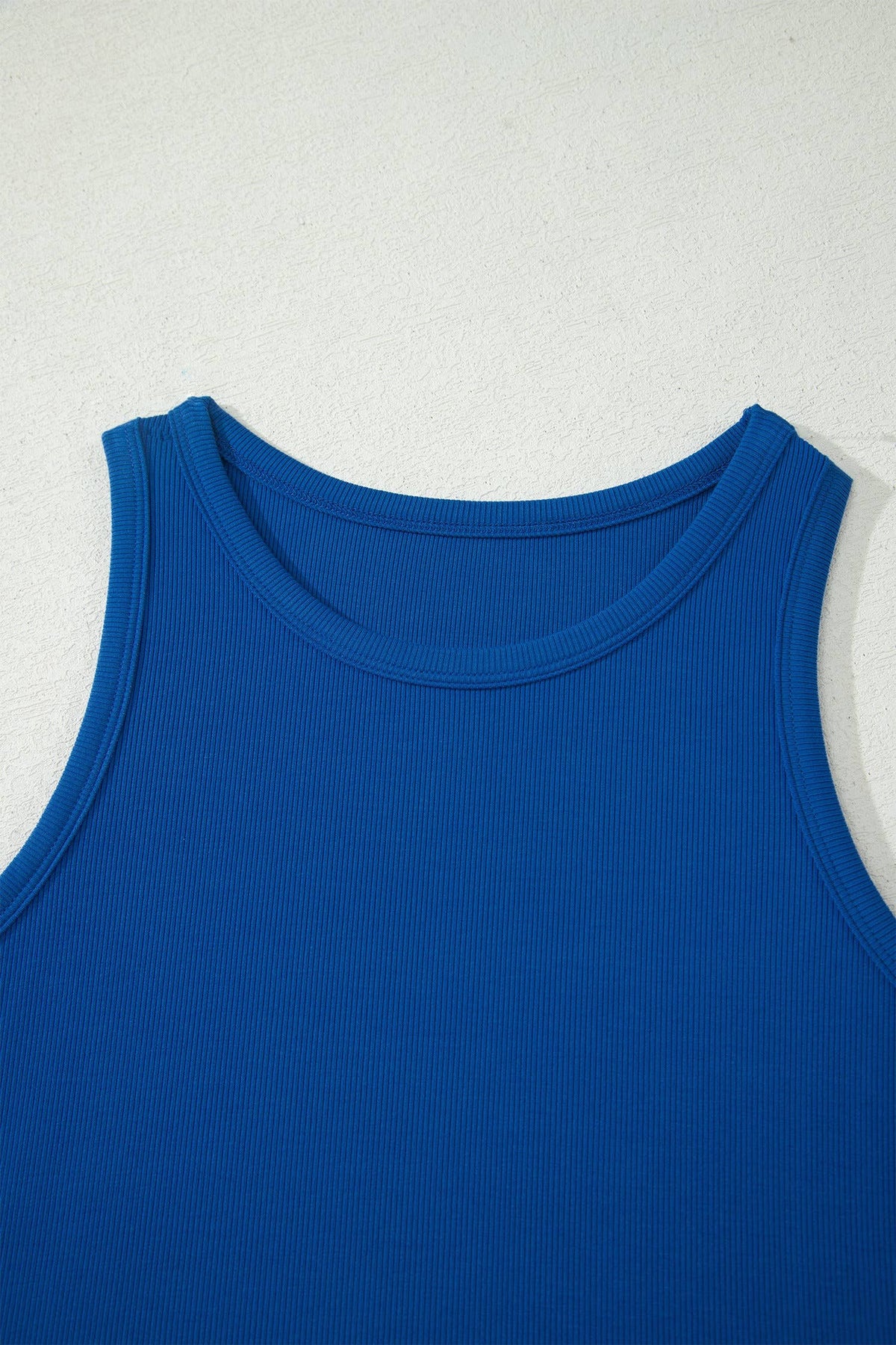 Blue tank top on a light gray background