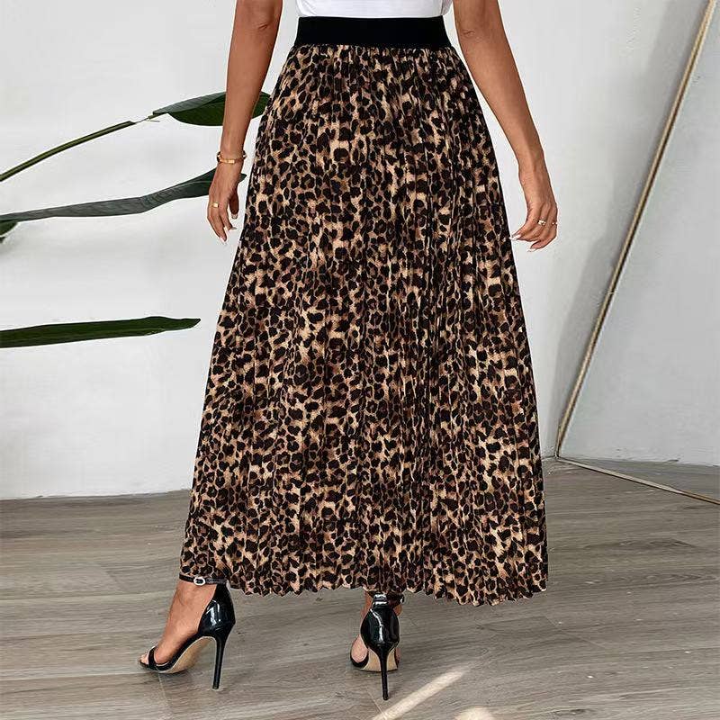 Person wearing a leopard print skirt with a white wall and plant in the background
