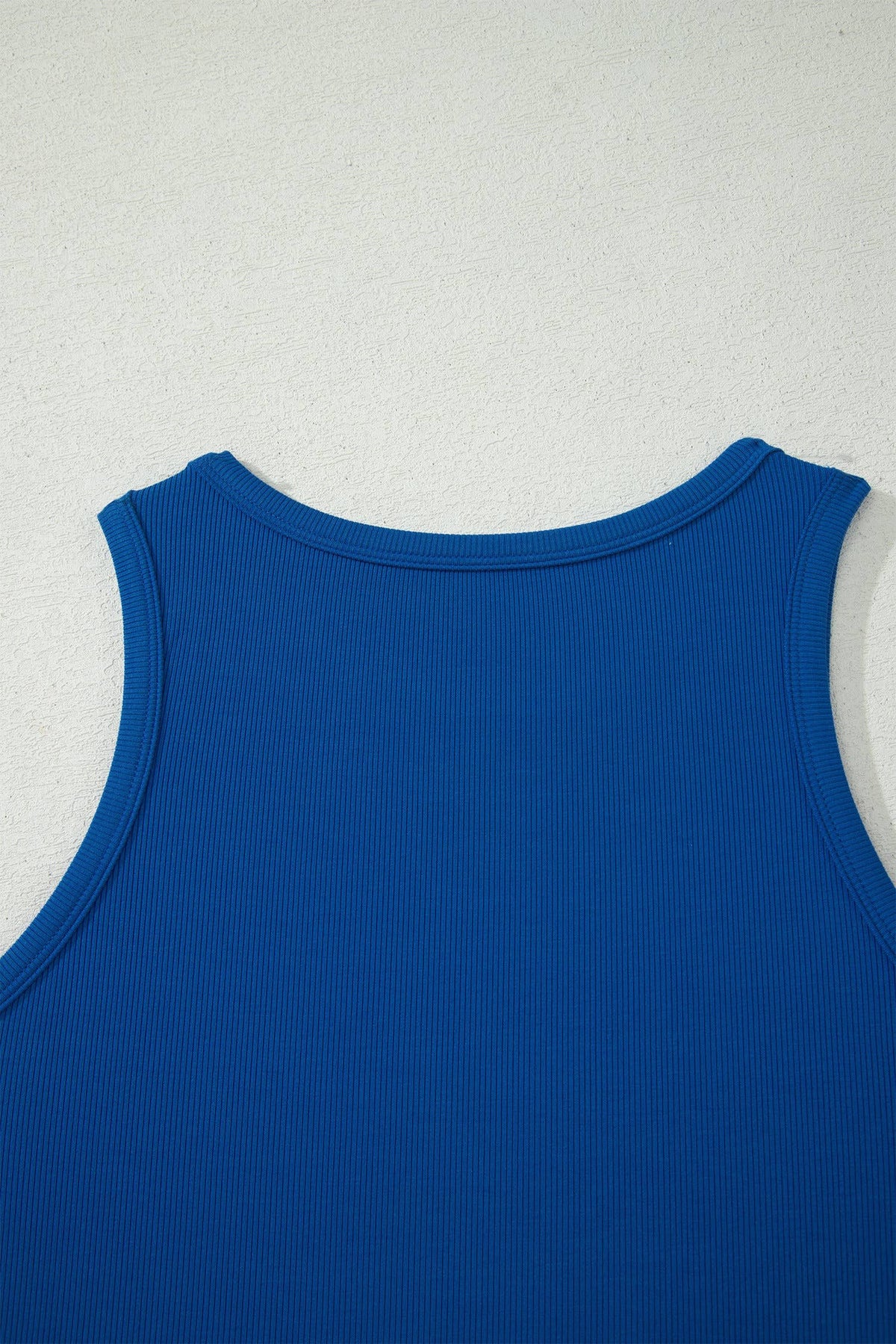 Blue tank top on a light gray background