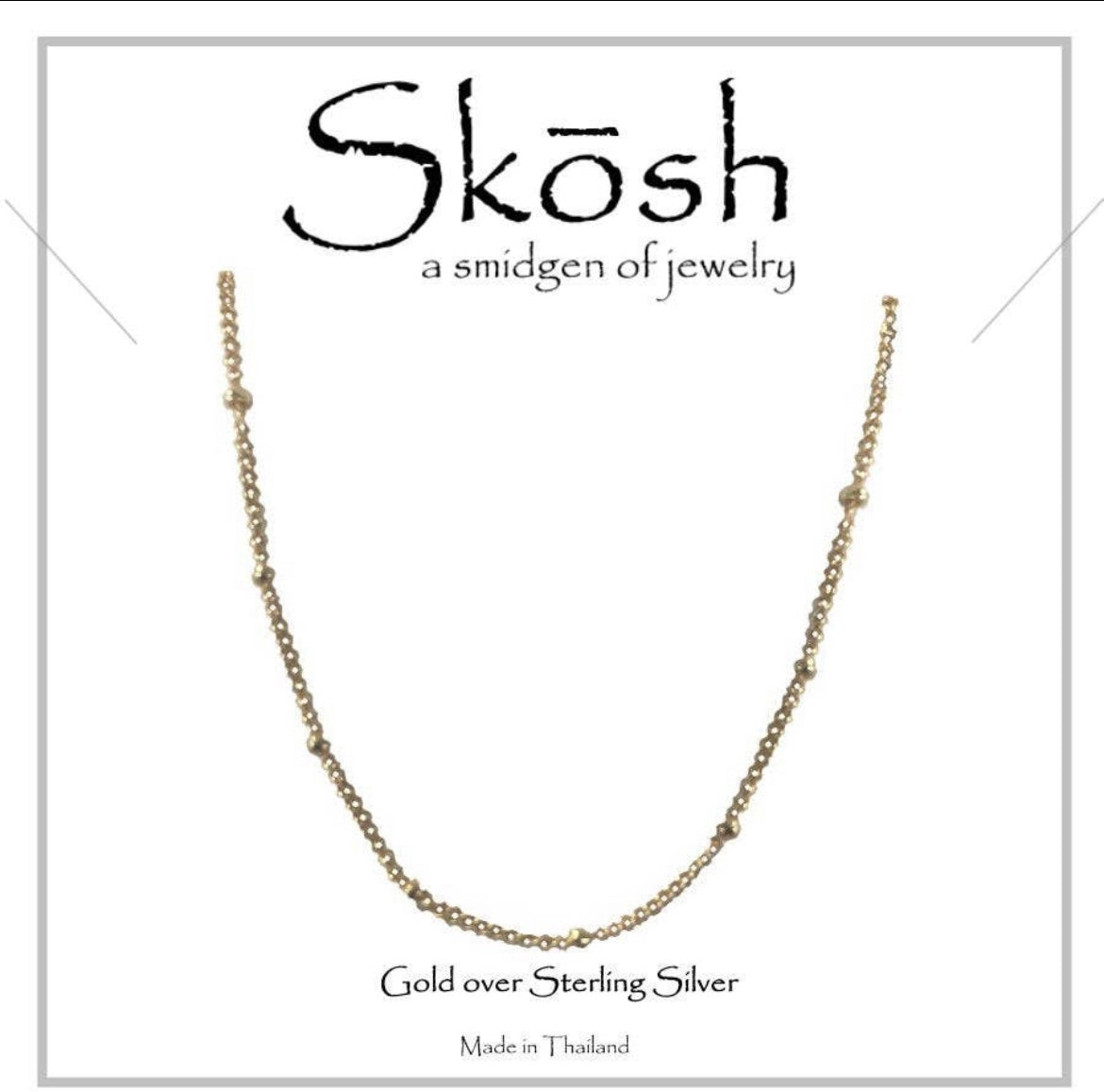 A 20-inch gold-colored necklace with a textured chain design, presented against a white background with the brand name 'Skosh' prominently displayed at the top.